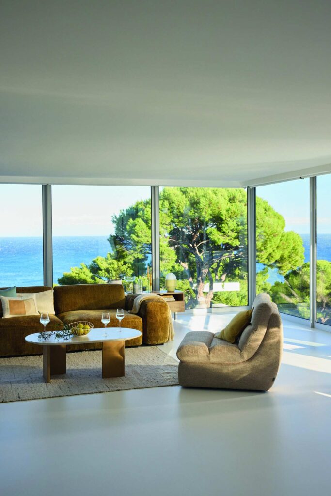Salon avec baies vitrées et vue panoramique sur la mer