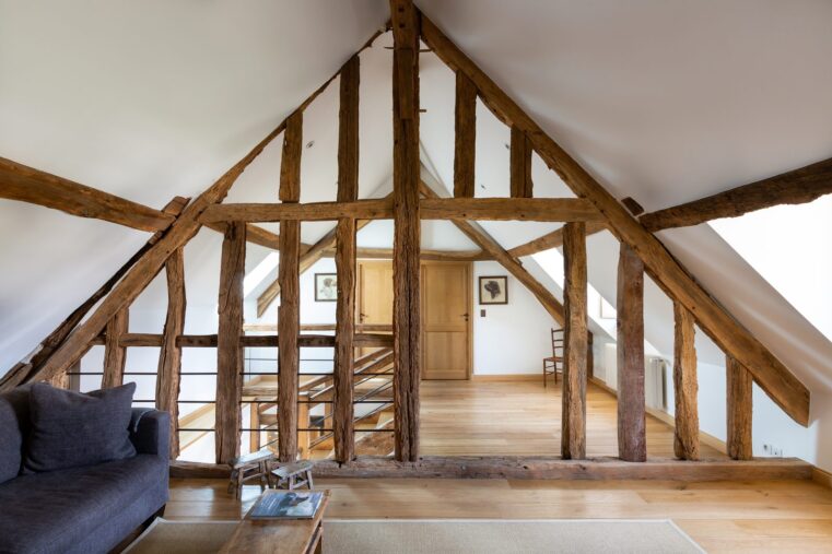 Grenier amenage en espace de vie avec charpente ancienne en bois et parquet chene